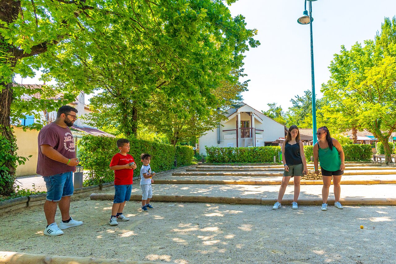 Family enjoying a game of p�tanque on the pitch at CAPFUN Duravel campsite (46).