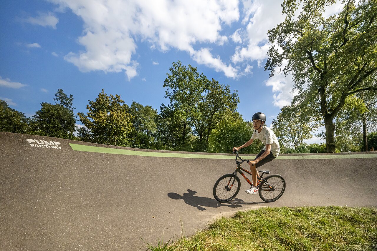 Young cyclist on pump track with BMX at CAPFUN Eibernest in Eibergen.