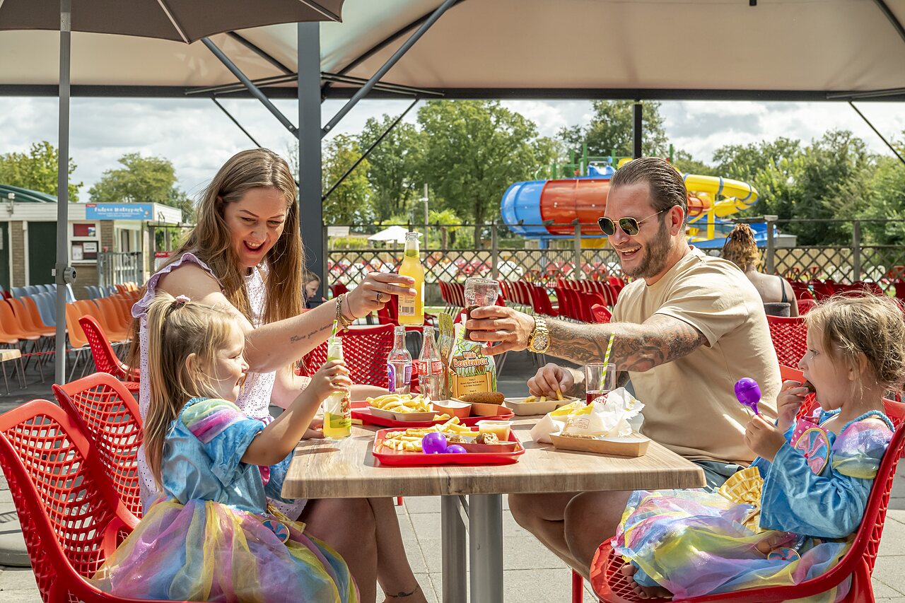 Family dining at outdoor restaurant, water slides, CAPFUN Eibernest campsite, Eibergen.