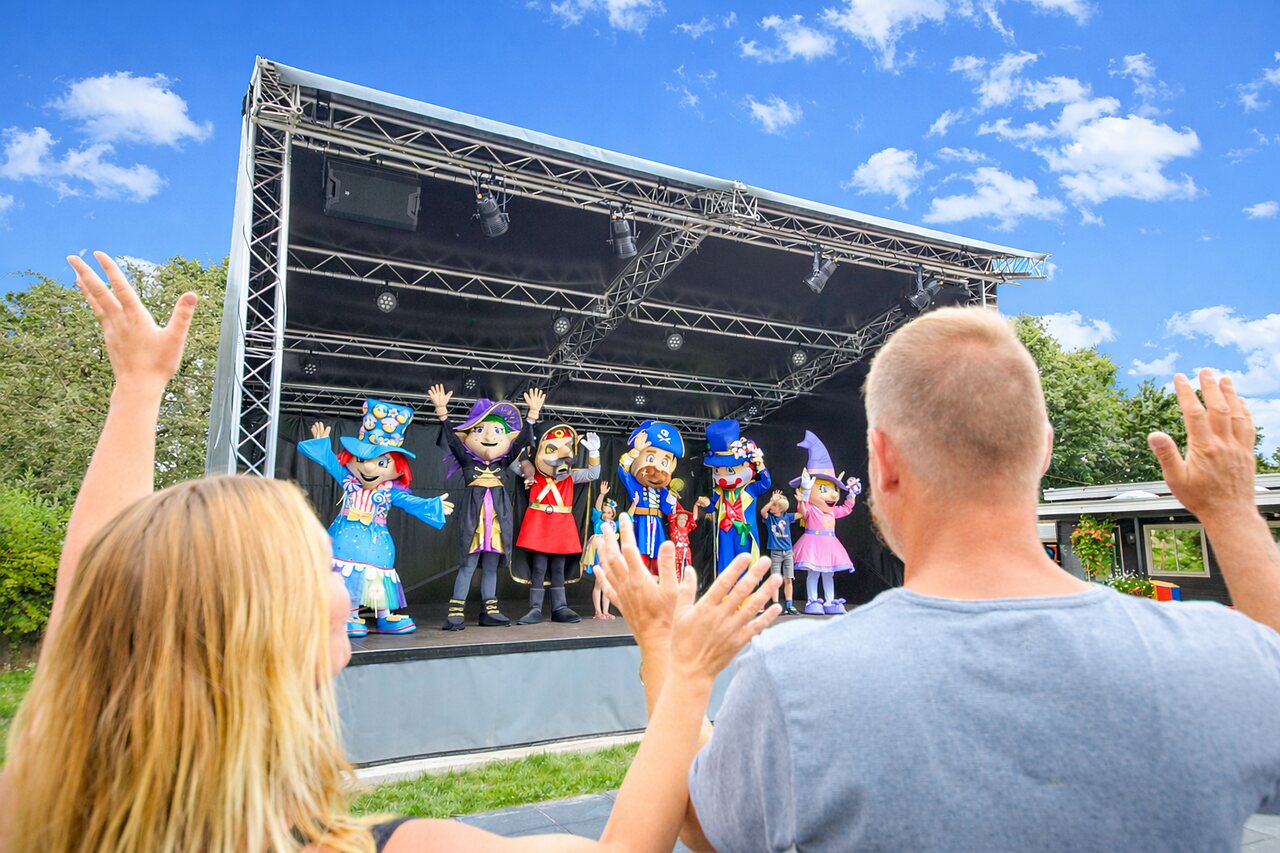 Colorful mascots on outdoor stage, entertainment show at CAPFUN Eibernest campsite in Eibergen.