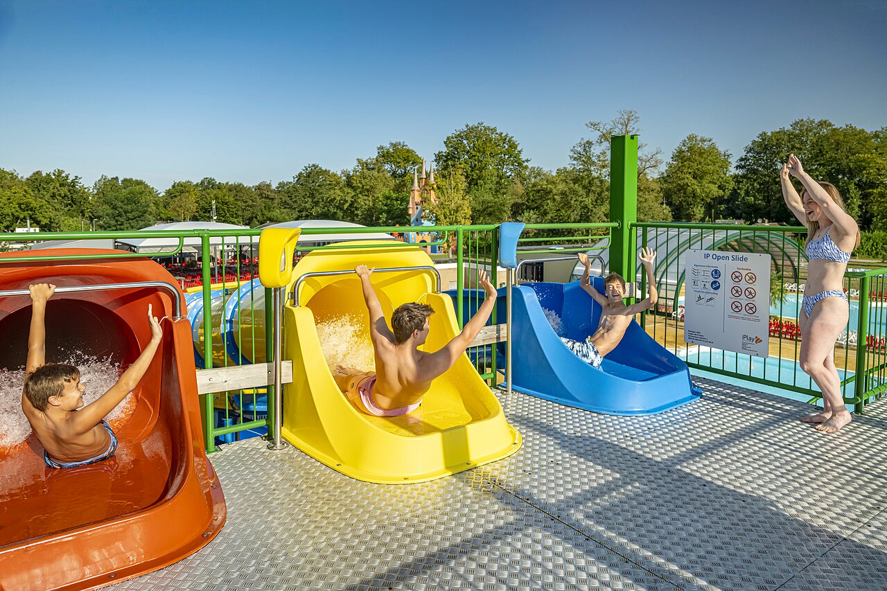 Children and adults enjoying colorful water slides at CAPFUN Eibernest campsite in Eibergen.