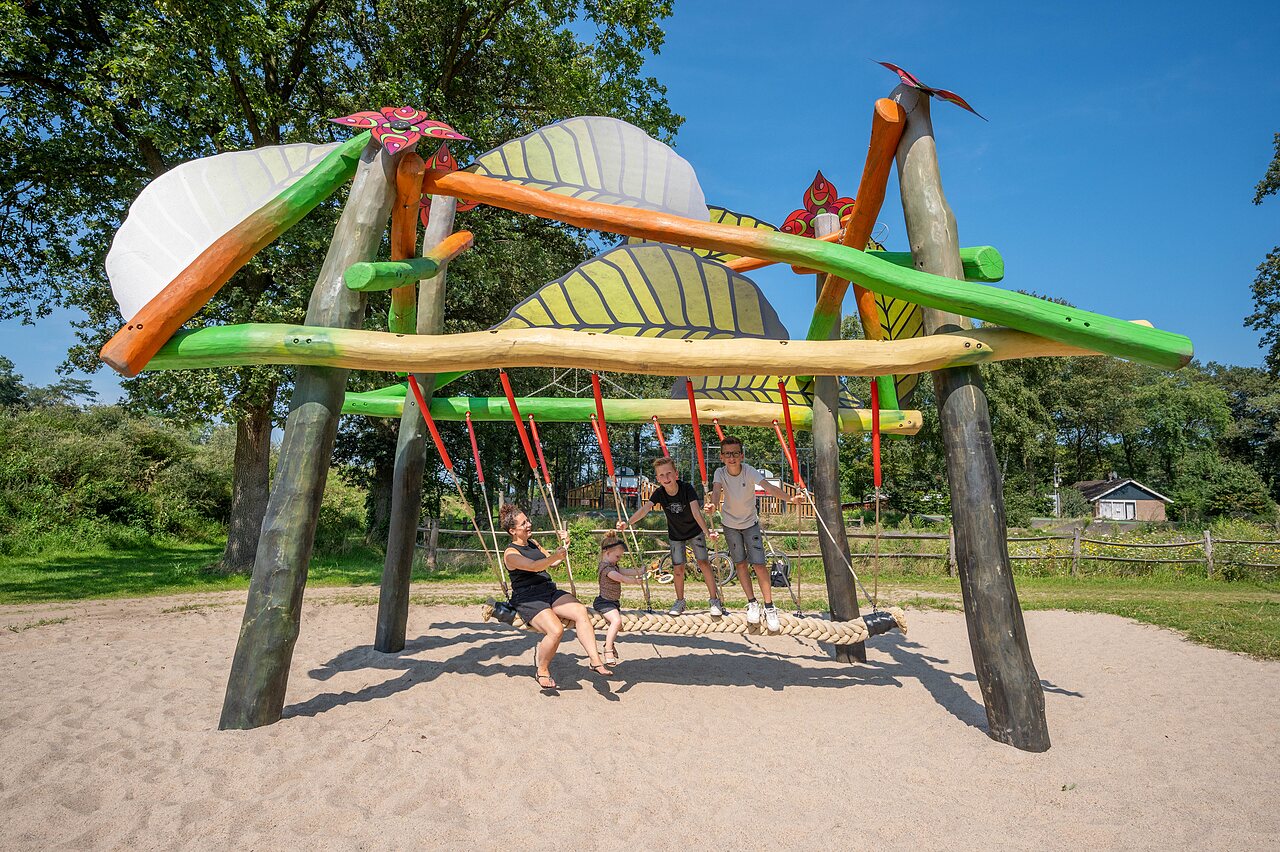 Themed giant swing with children at CAPFUN Eibernest campsite in Eibergen.