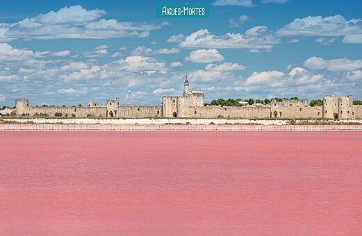 Historic ramparts of Aigues-Mortes and its famous pink salt marshes in Camargue.