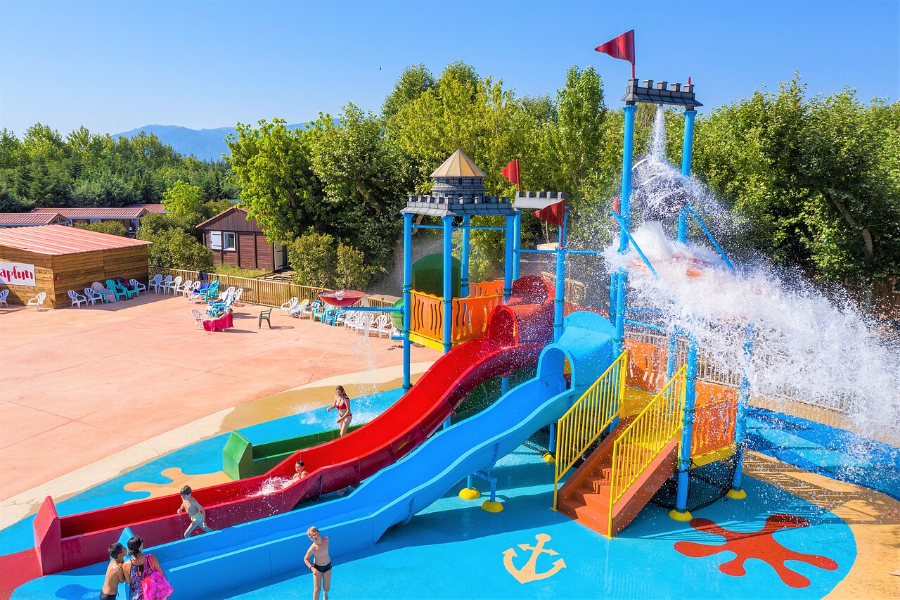 Colorful slides and water play area at CAPFUN El Moli campsite in Elne (66).