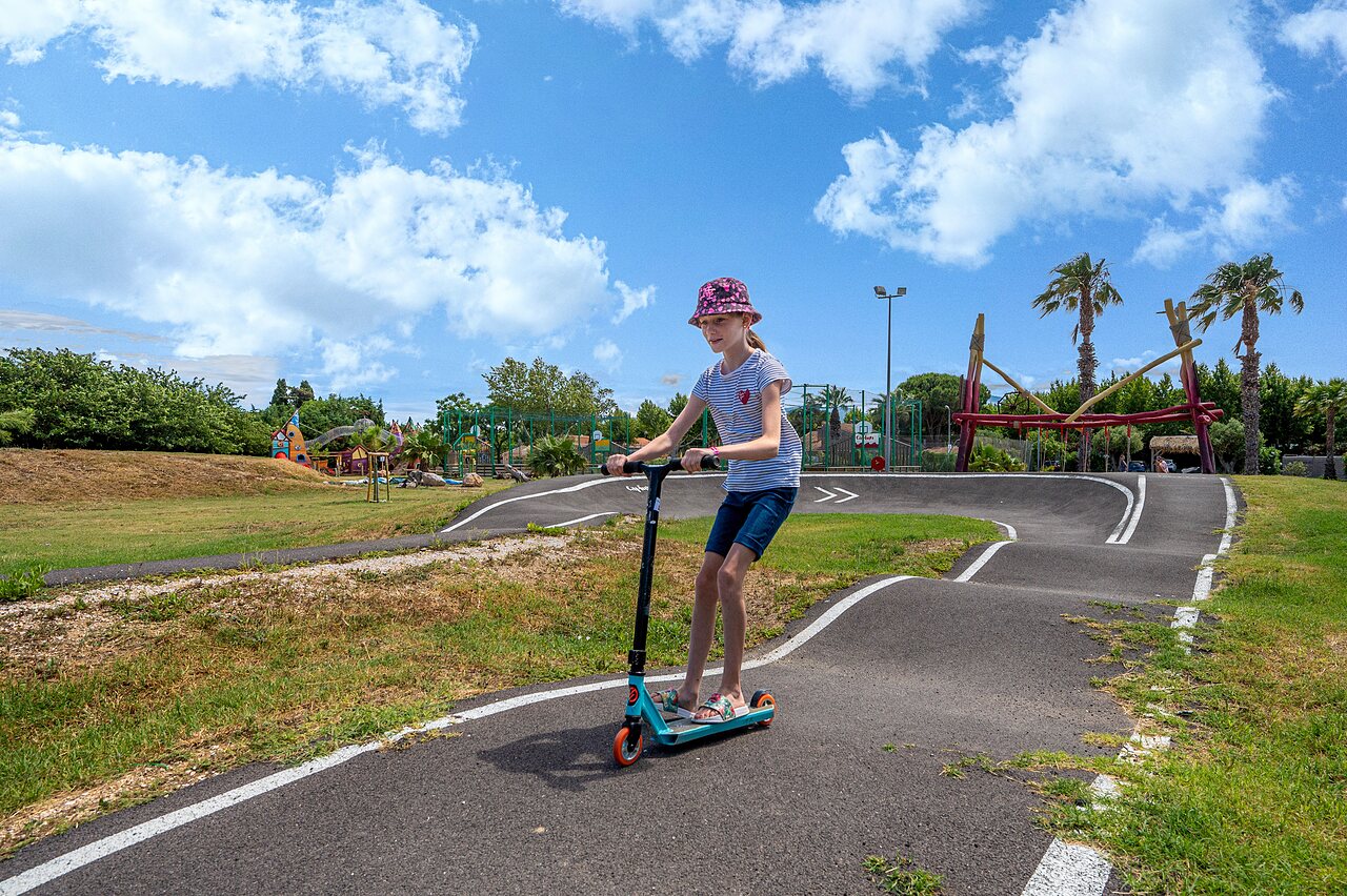 Child on scooter, CAPFUN El Moli campsite in Elne (66).