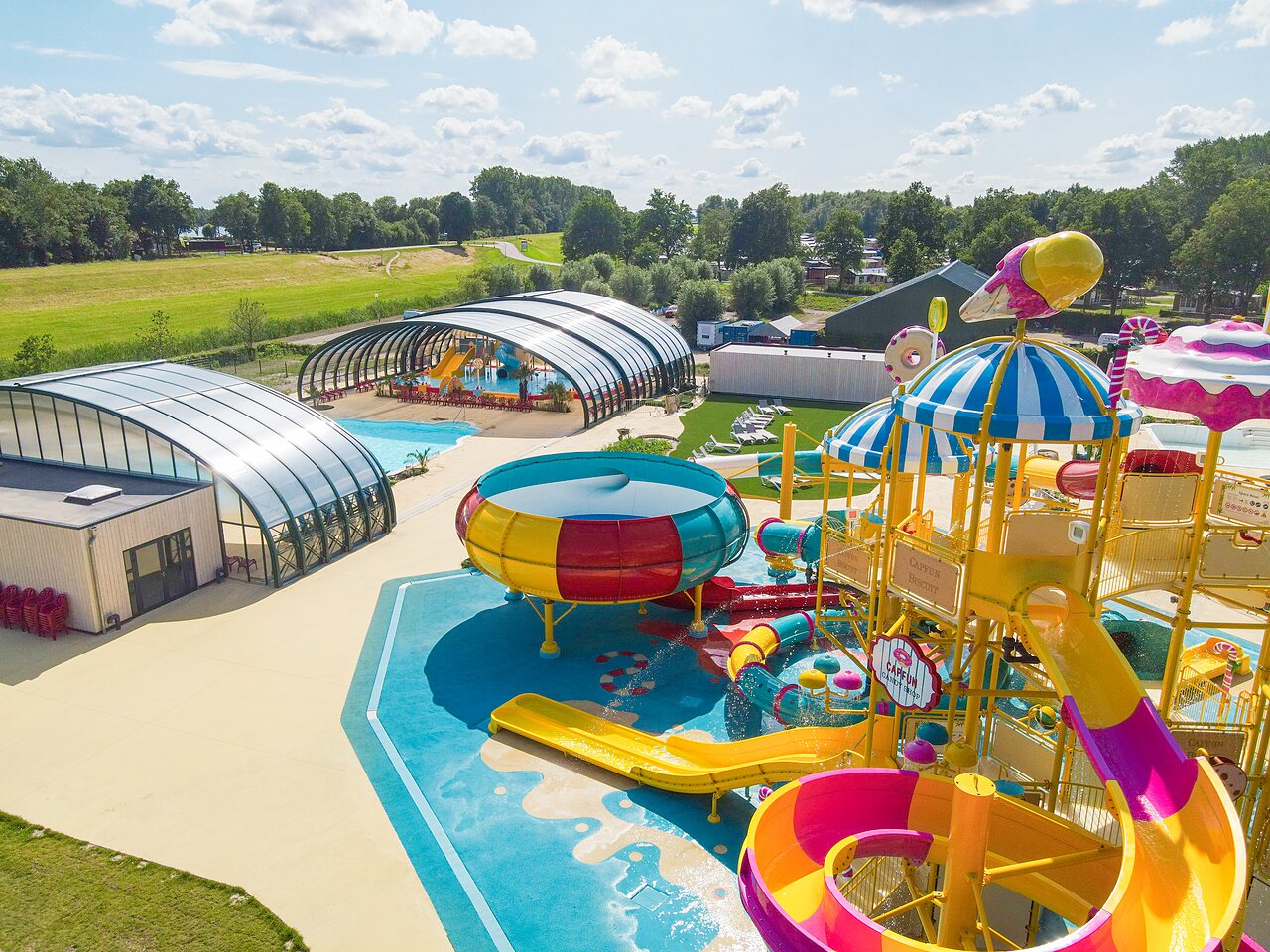 Colorful water park with slides and covered pools at CAPFUN Erkemederstrand campsite in Zeewolde.