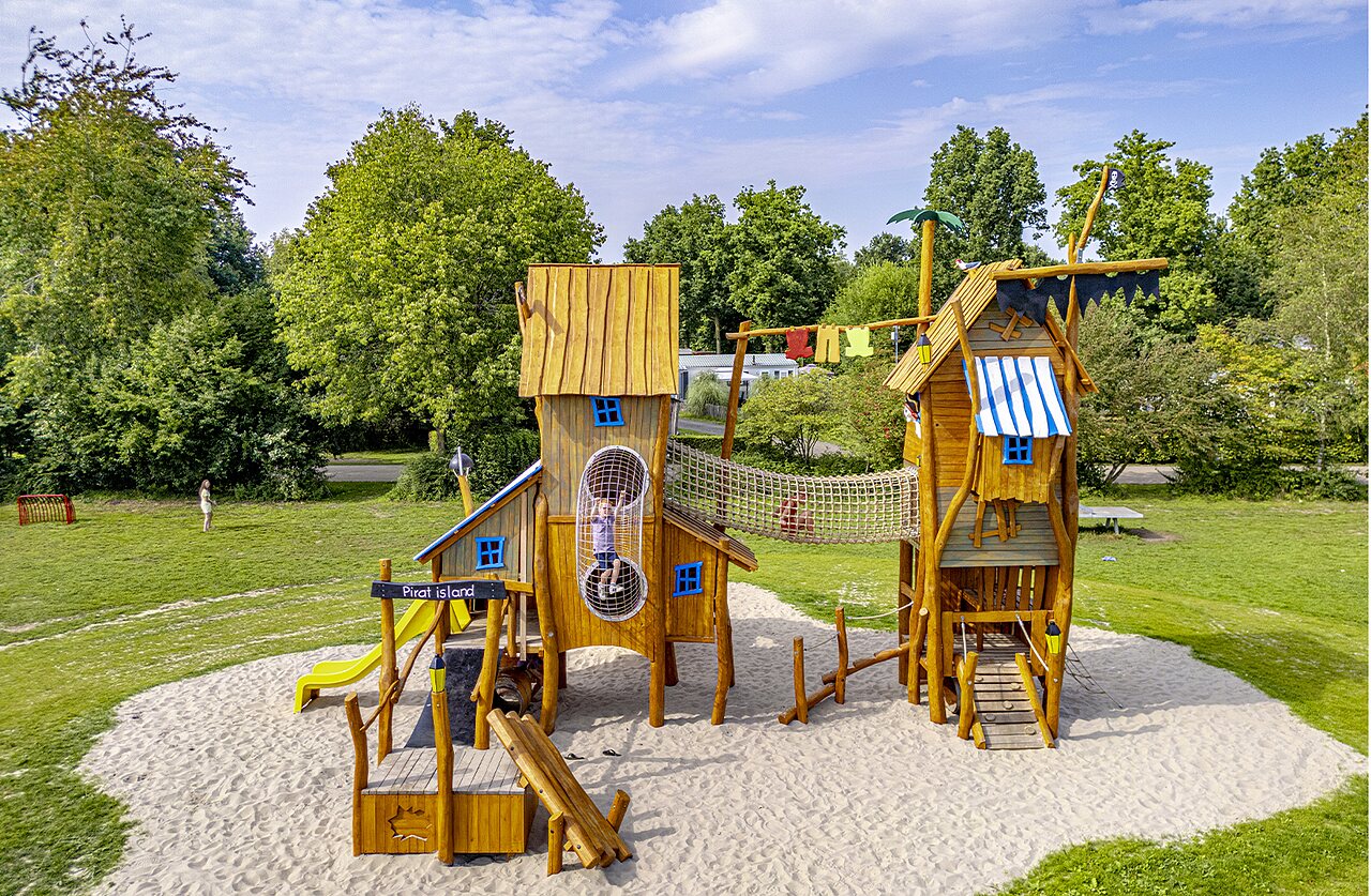 Large wooden pirate playground with slide at CAPFUN Erkemederstrand campsite in Zeewolde.