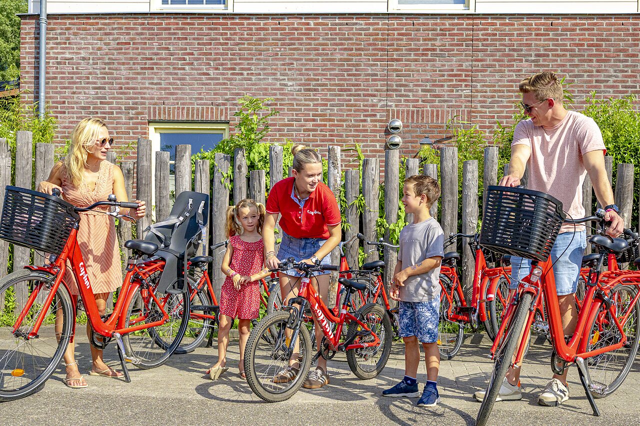 Family renting Capfun bikes with child seat at CAPFUN Erkemederstrand, Zeewolde.