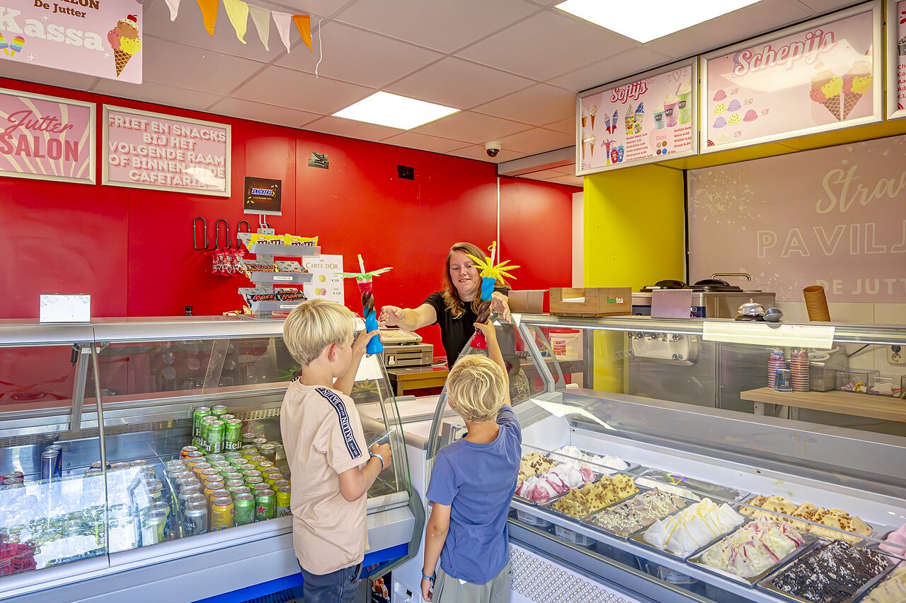 Children receiving ice cream at the snack bar of CAPFUN Erkemederstrand campsite in Zeewolde.