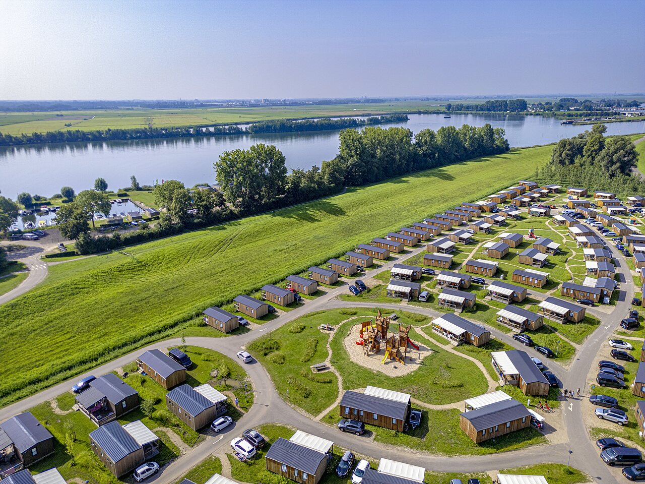 Mobile homes and playground at CAPFUN Erkemederstrand campsite in Zeewolde.