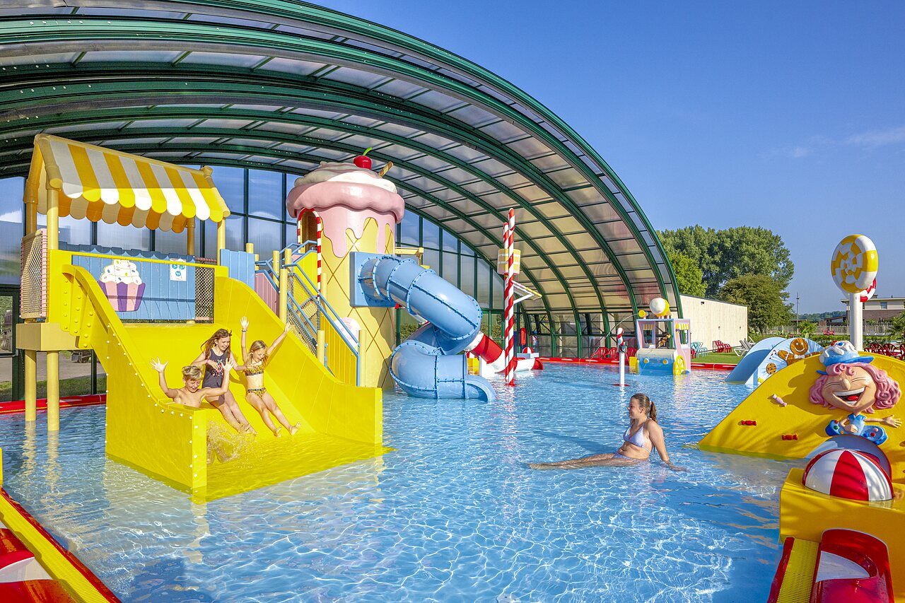 Covered pool, waterslides and aquatic games at CAPFUN Erkemederstrand, Zeewolde.