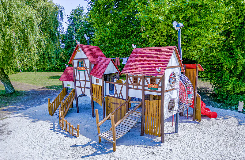 Themed playground with slide at VAGUES OCEANES Lac d'Erstein campsite.