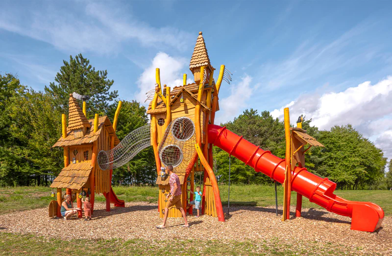 Wooden playground, red slide at CLICOCHIC campsite in HARPRICH.
