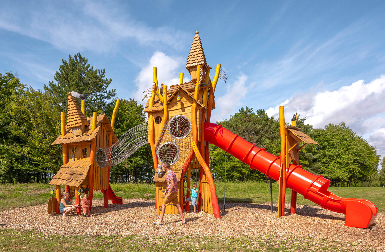 Wooden playground, red slide at CLICOCHIC campsite in HARPRICH.