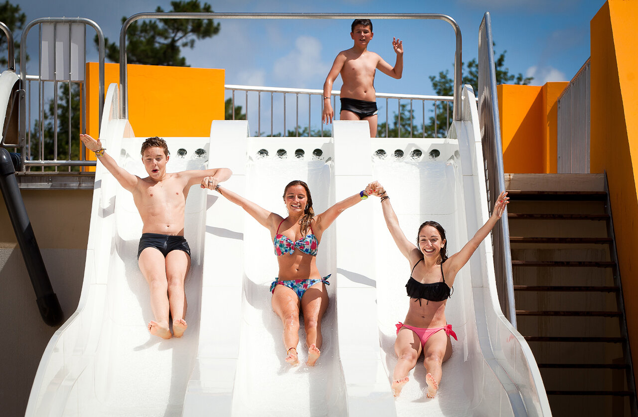 Water slides, young people at CLICOCHIC Etang de la Mutche camping, HARPRICH (57).