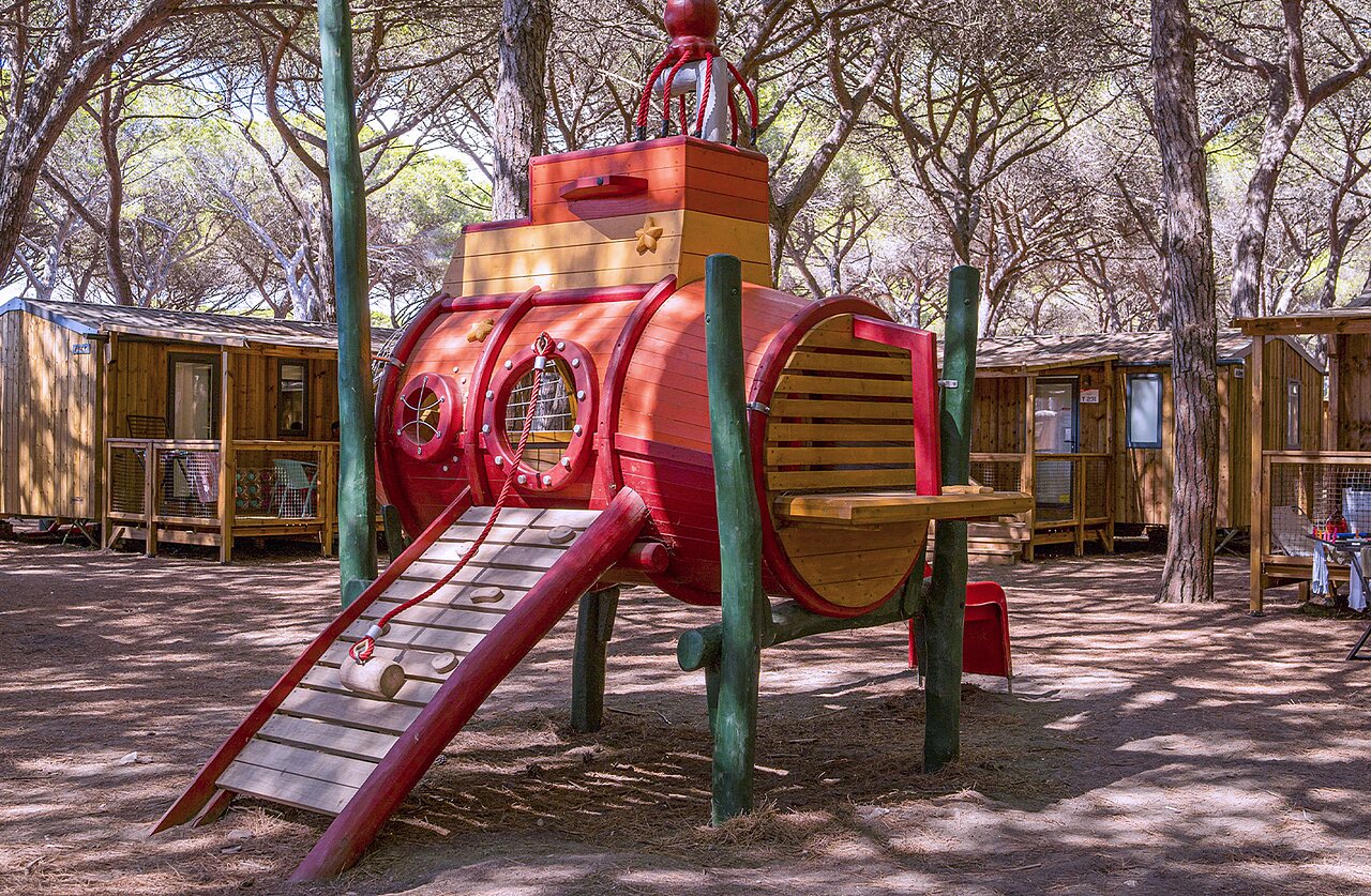 Submarine playground and Mobile homes under pines at CAPFUN Europing campsite Tarquinia.