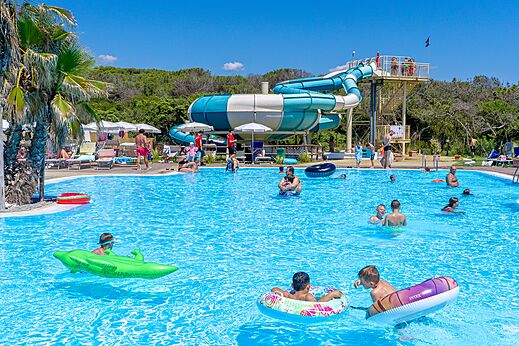 Outdoor swimming pool with giant water slide at CAPFUN Europing campsite in Tarquinia (01).
