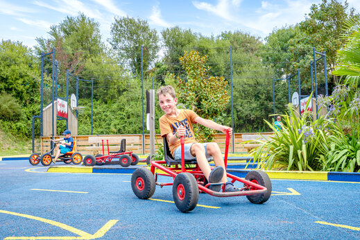Children playing with pedal go-karts on a track at CAPFUN L'Eve campsite in Saint-Marc-sur-Mer (44).