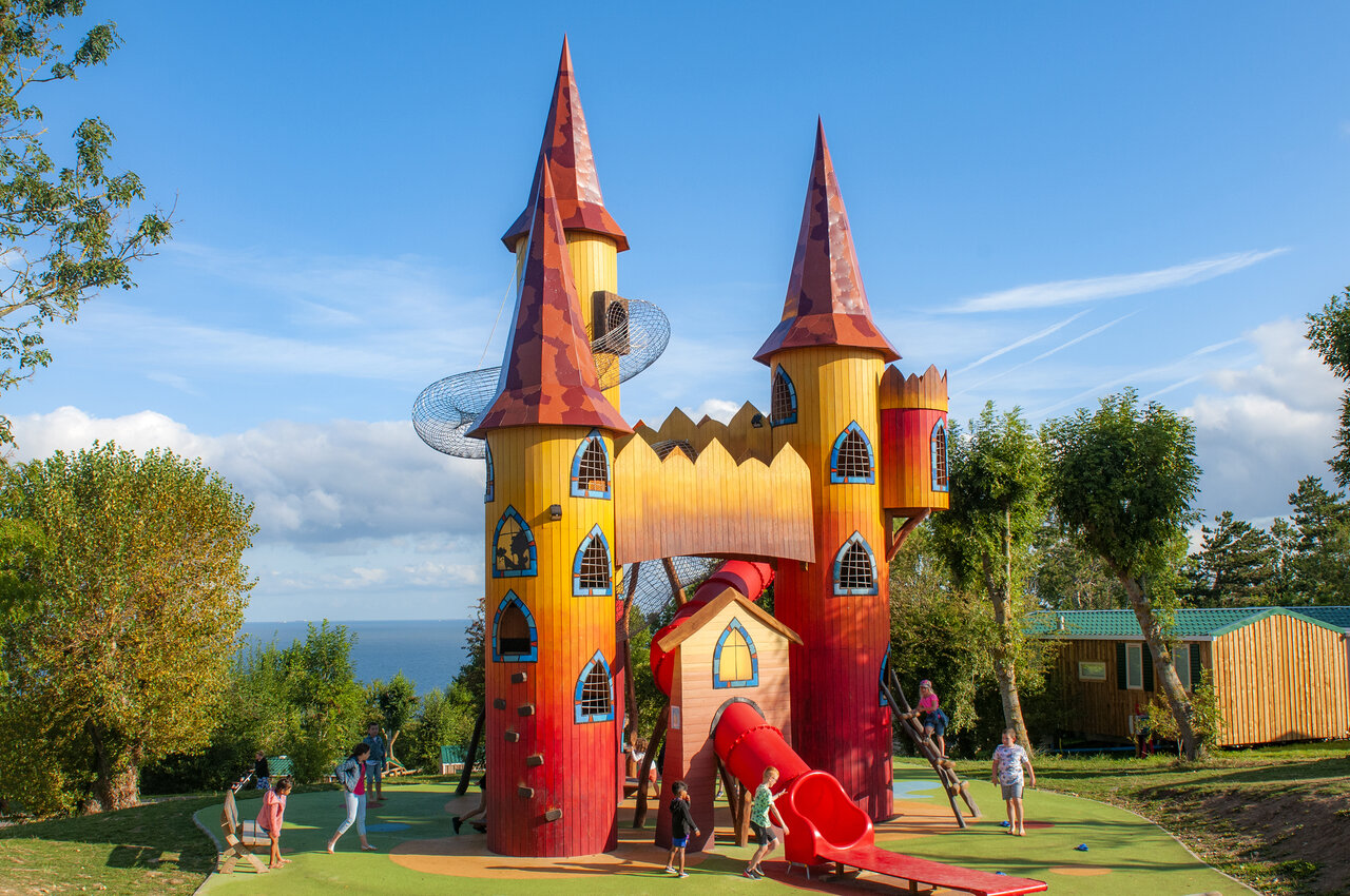 Giant castle playground, slides, children at CAPFUN Falaises campsite in Gonneville sur Mer (14).