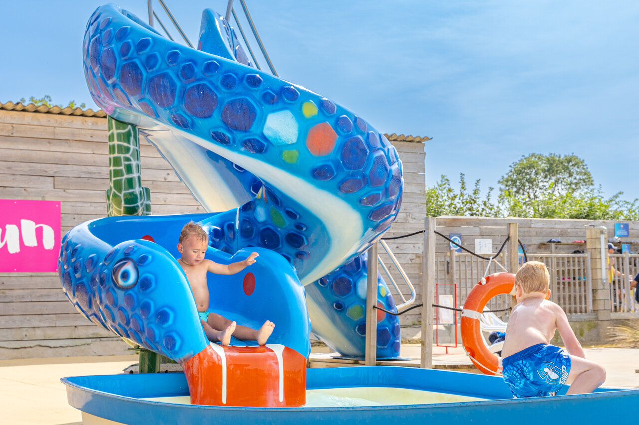 Blue snake water slide, children playing at CAPFUN Falaises Gonneville sur Mer.