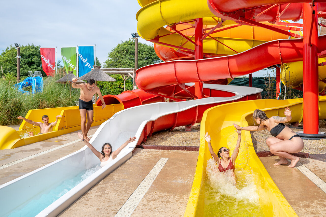 Colorful water slides and happy people at CAPFUN F�erix campsite in MARSEILLAN PLAGE.
