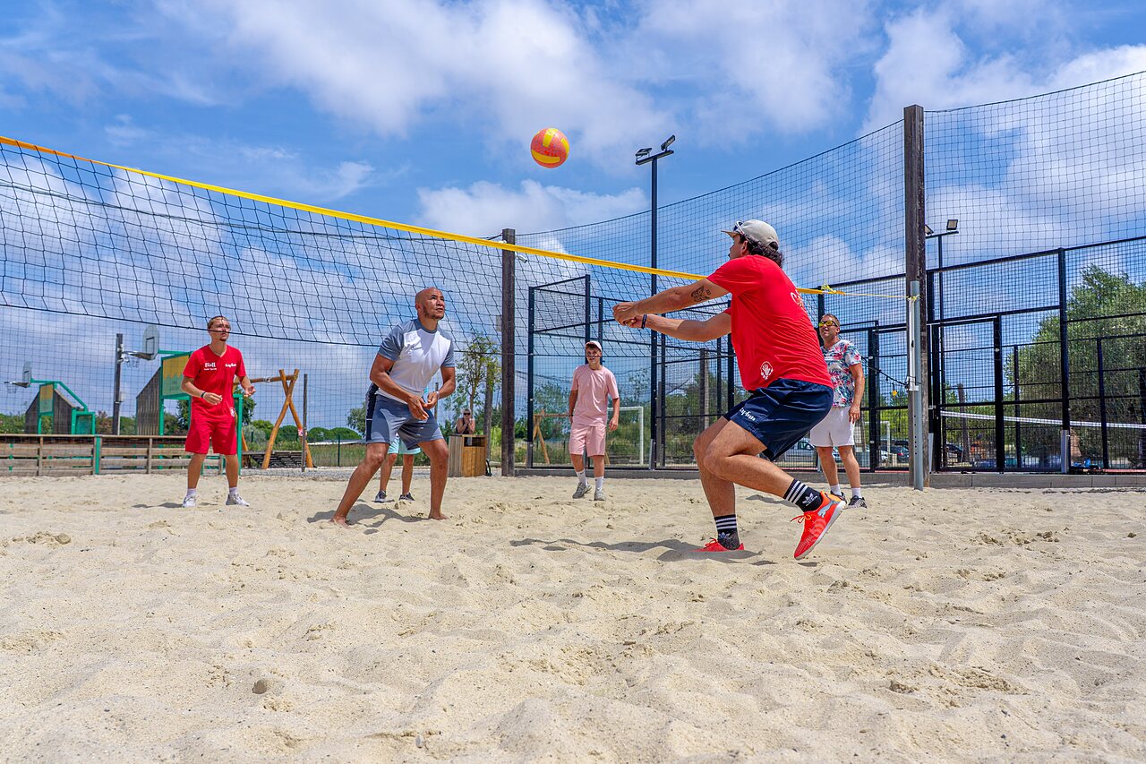 Active players on the beach volleyball court at camping CAPFUN Fleurs d'Agde in AGDE (34).