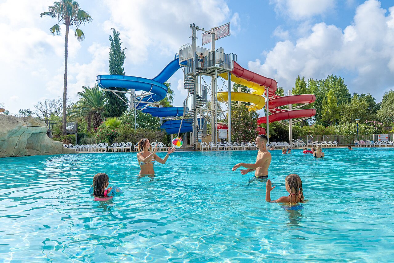 Outdoor swimming pool and water slides at CAPFUN Fleurs d'Agde campsite in AGDE (34).