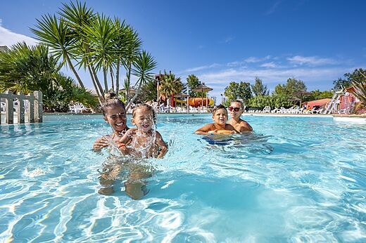 Outdoor pool, family and children at CAPFUN Fleurs d'Agde campsite in AGDE.