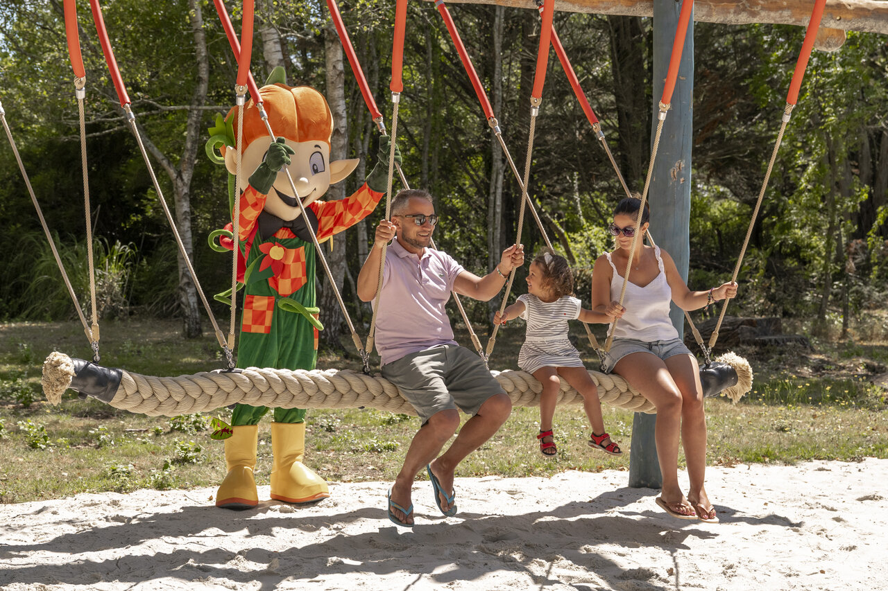 Family and mascot on giant swing at CLICOCHIC La For�t d'Azal�e campsite in Saint-Ch�ron (91).
