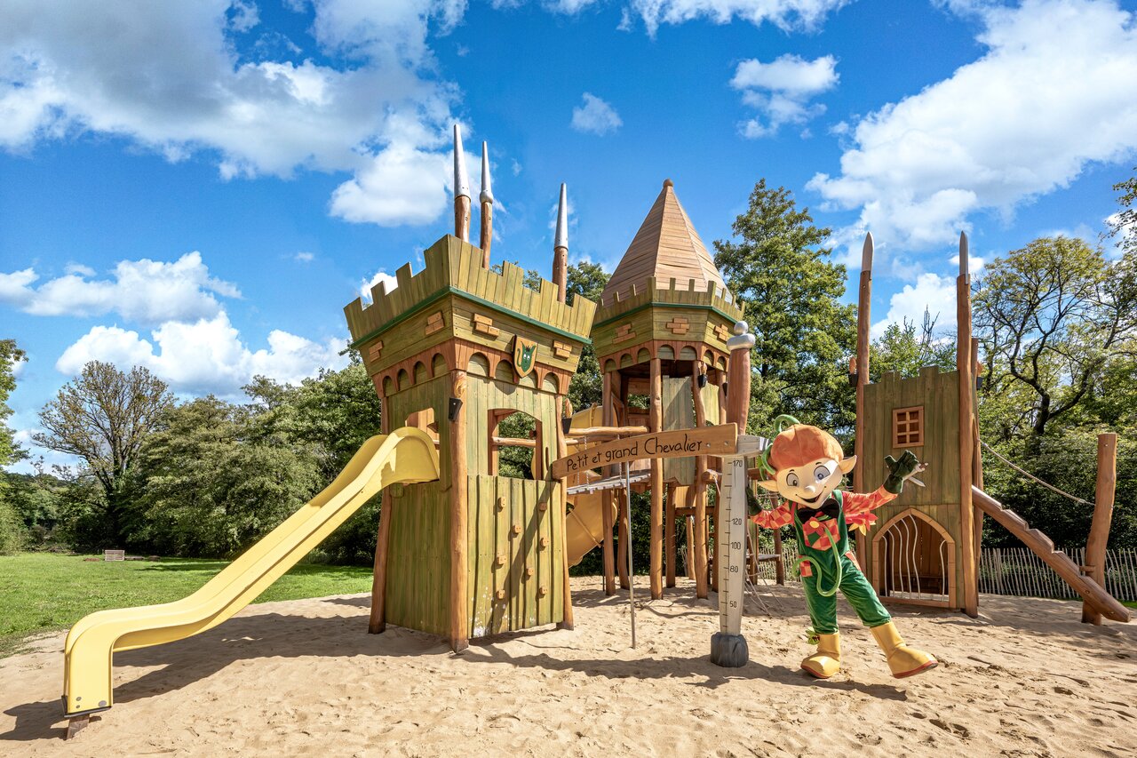 Castle playground, slide and mascot at CLICOCHIC Forge Sainte Marie campsite.