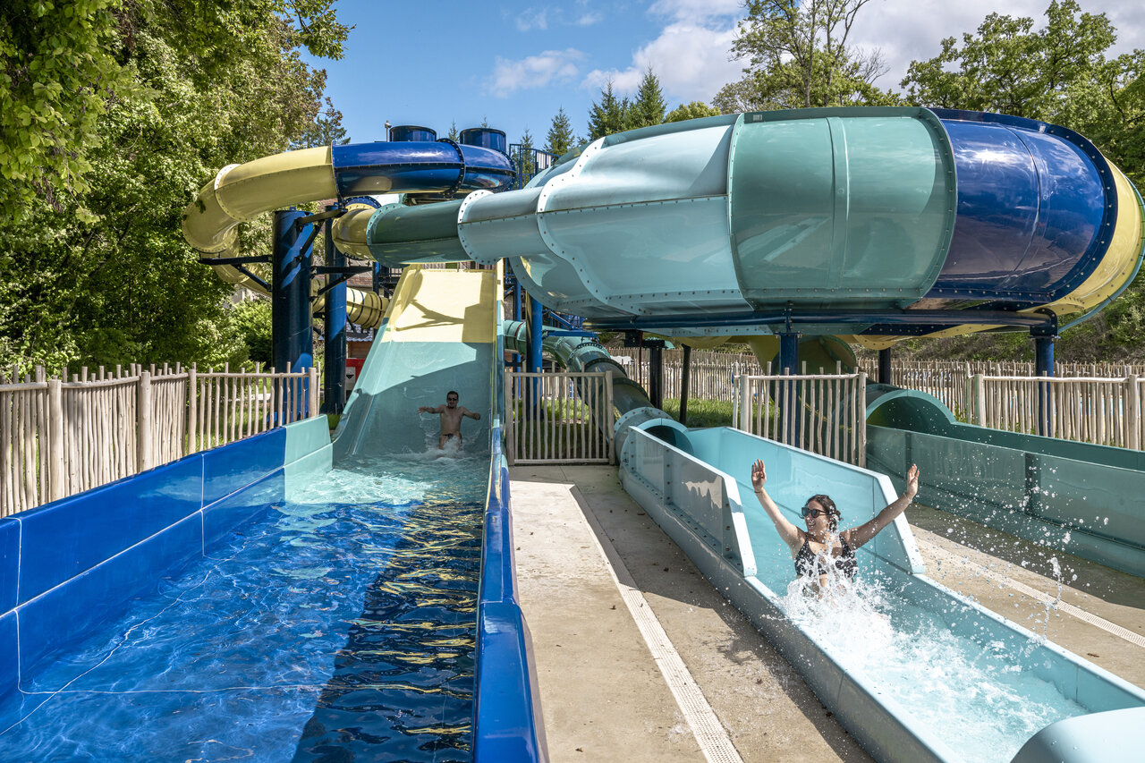 Water slides and outdoor swimming pool at CLICOCHIC Forge Sainte Marie campsite.