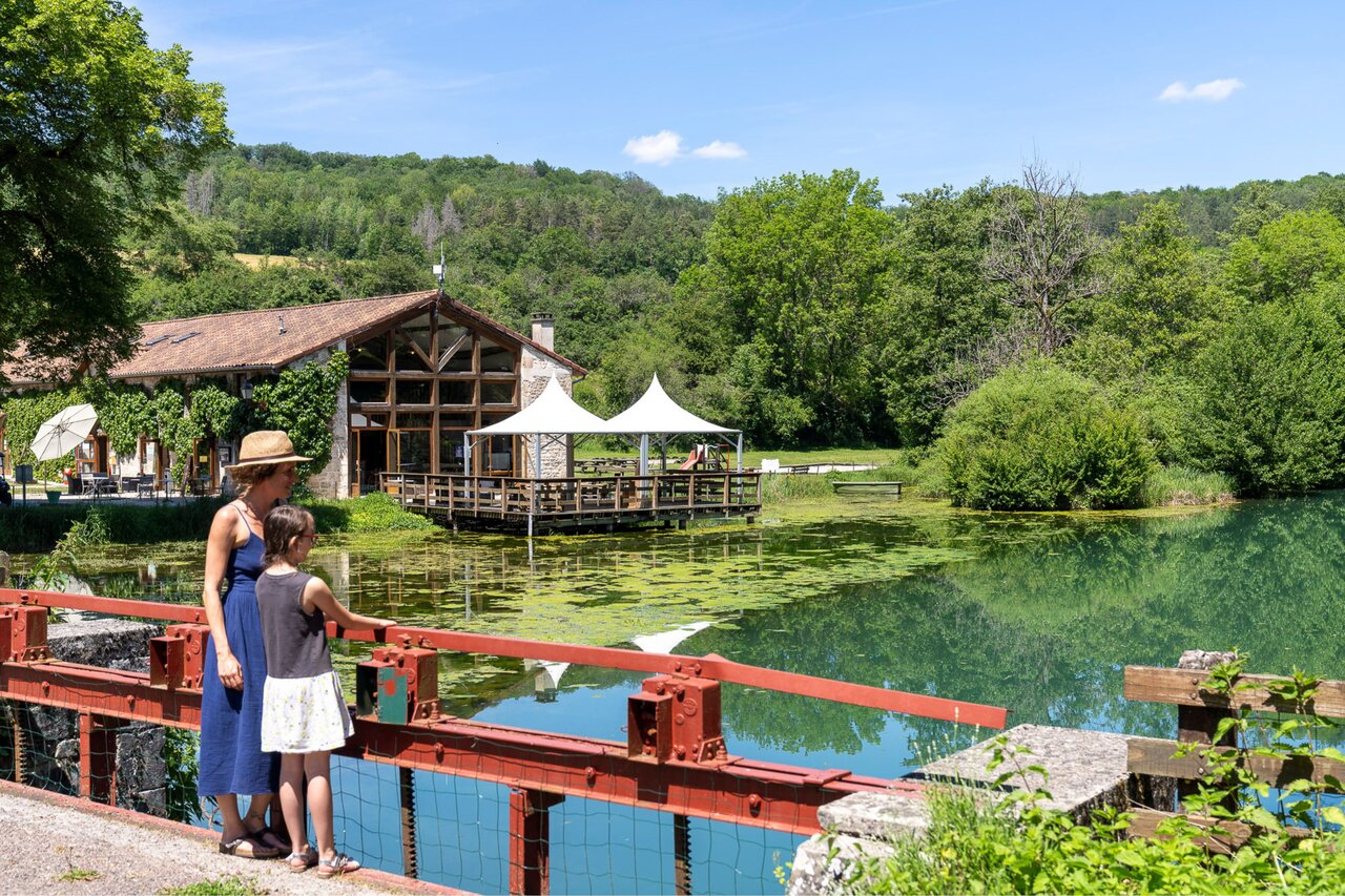 Restaurant with overwater terrace, green surroundings at CLICOCHIC Forge Sainte Marie.