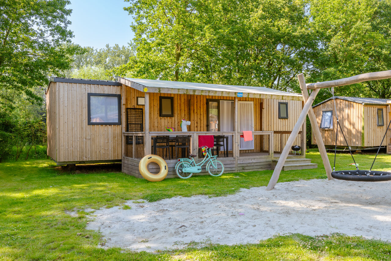 Mobile home, swing set at CAPFUN Fort Bedmar campsite in Sint-Gillis-Waas.