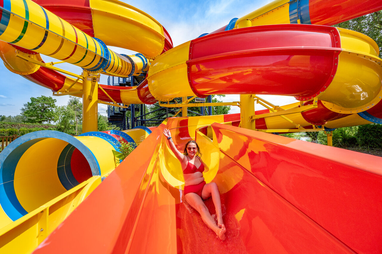 Woman on giant water slide at CAPFUN Fort Falabraque campsite in Seltz (67).