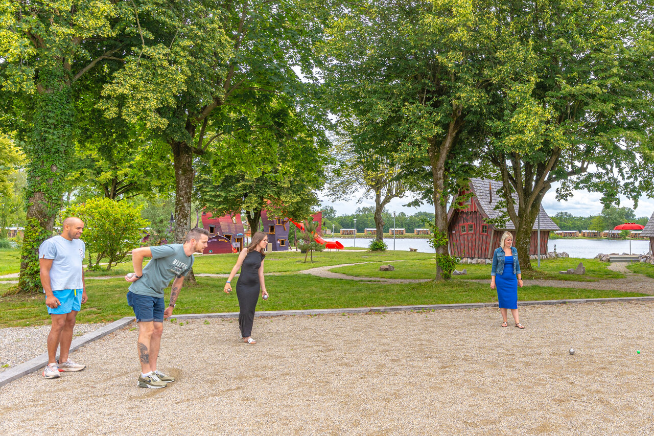 Petanque court with players at CAPFUN Fort Falabraque campsite in Seltz (67).