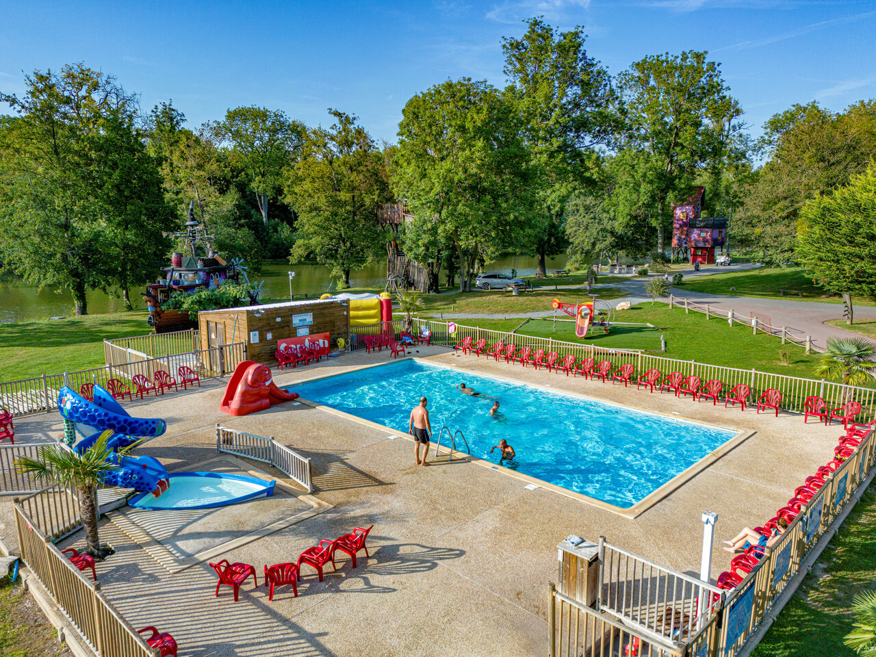 Outdoor pool with water slides and paddling pool at CAPFUN Fredland campsite in Tournan en Brie (77).