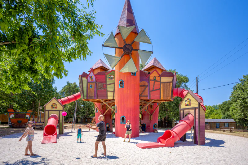 Large colorful playground structure with slides and sand at CAPFUN Le Fr�jus campsite in Fr�jus (83).
