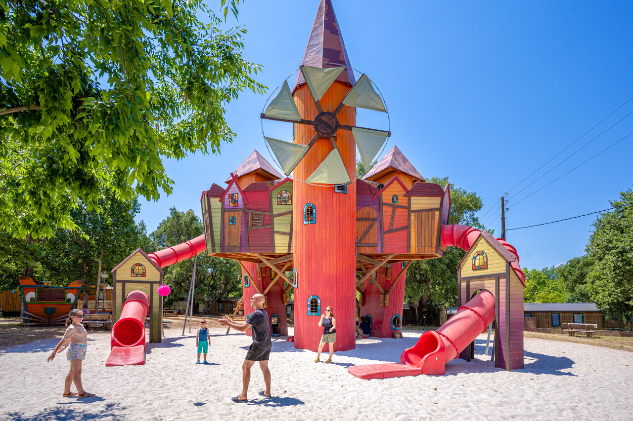 Large colorful playground structure with slides and sand at CAPFUN Le Fr�jus campsite in Fr�jus (83).