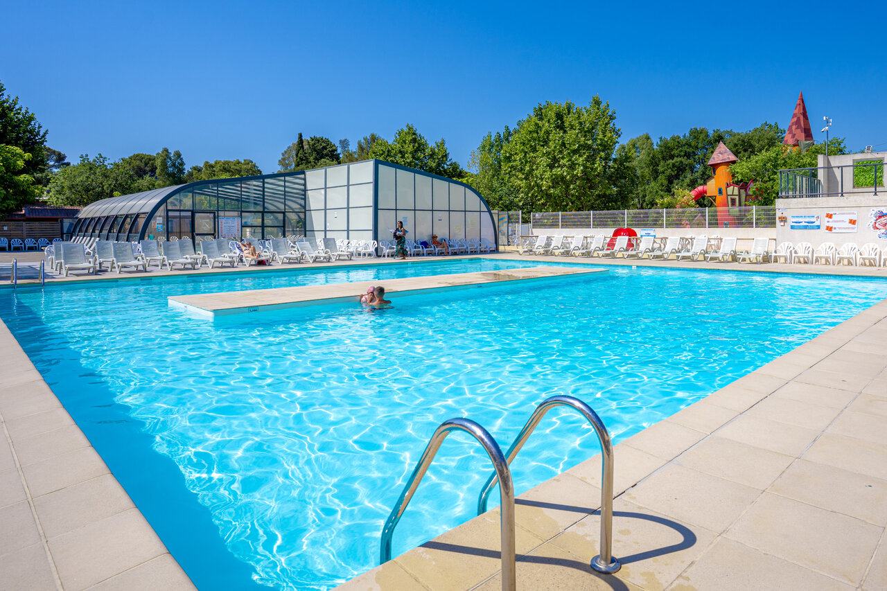 Outdoor pool, covered pool and playground at CAPFUN Le Fr�jus campsite.