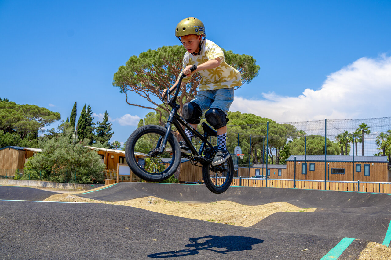 Child on BMX jumping on the pump track at CAPFUN Le Fr�jus.