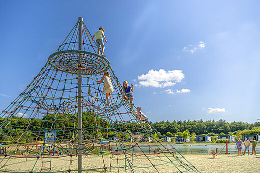 Children on rope pyramid at CAPFUN De Fruithof campsite in Klijndijk.