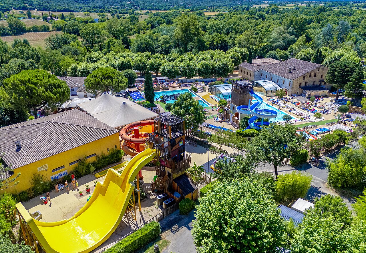 Aerial view of water park with giant slides and pools at CAPFUN Fumades campsite in ALLEGRE-LES-FUMADES (30).