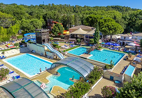 Aerial view of large water park with pools and slides at CAPFUN Fumades campsite in ALLEGRE-LES-FUMADES (30).