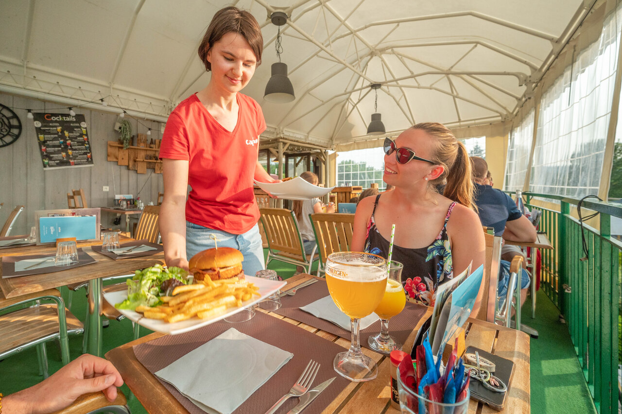 Burger and fries served on terrace at CAPFUN Fuvettes, Malbuisson.