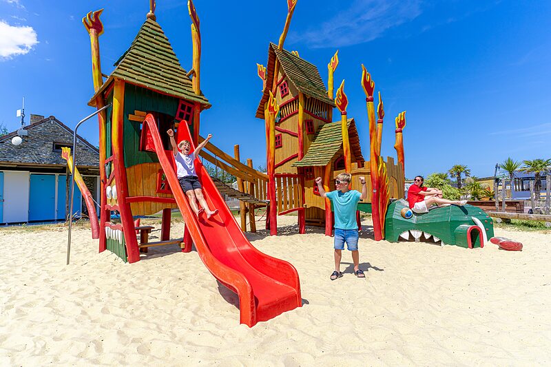 Carabouille playground - Colorful playground with slide and happy children at CAPFUN Golf campsite in SAINT JEAN DE LA RIVIERE (50).