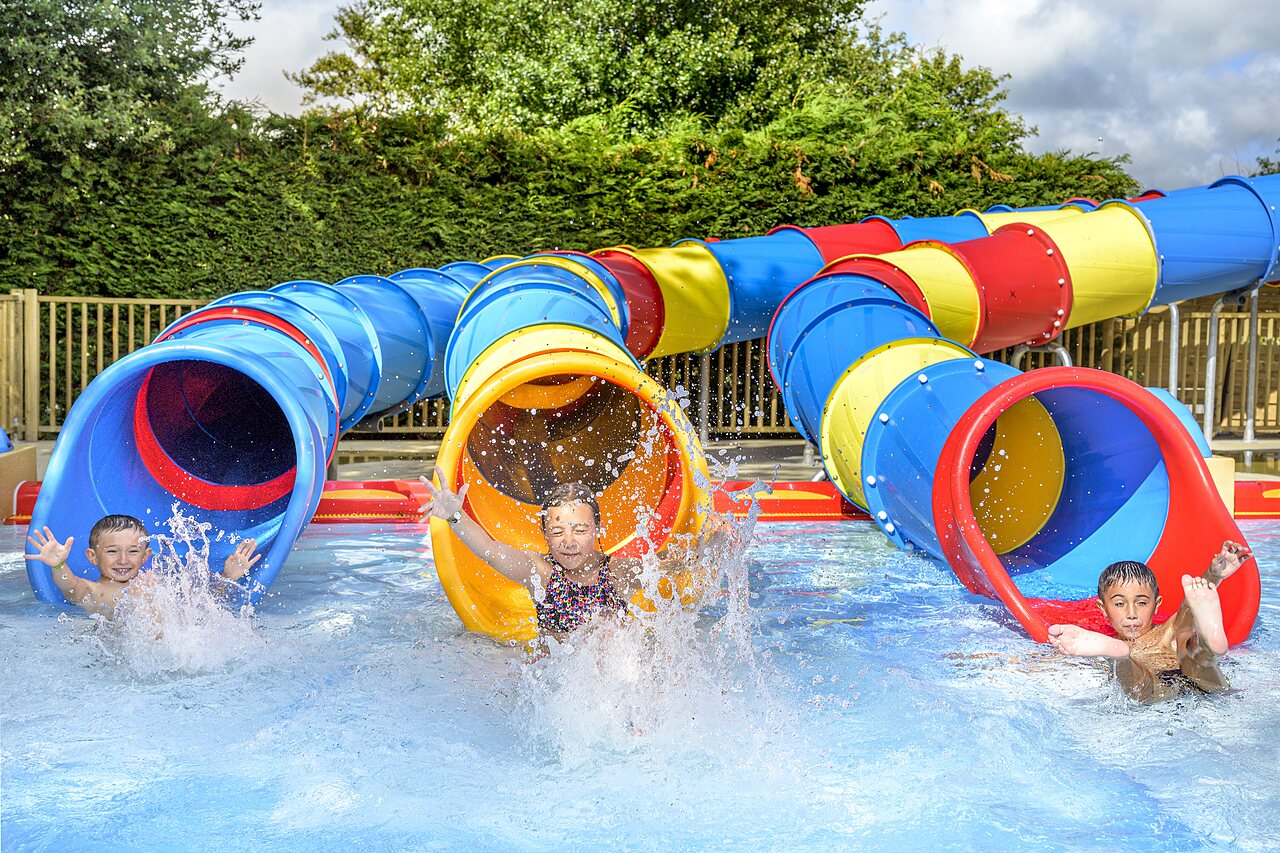 Children, water slides, swimming pool at CAPFUN Golf campsite in SAINT JEAN DE LA RIVIERE (50).