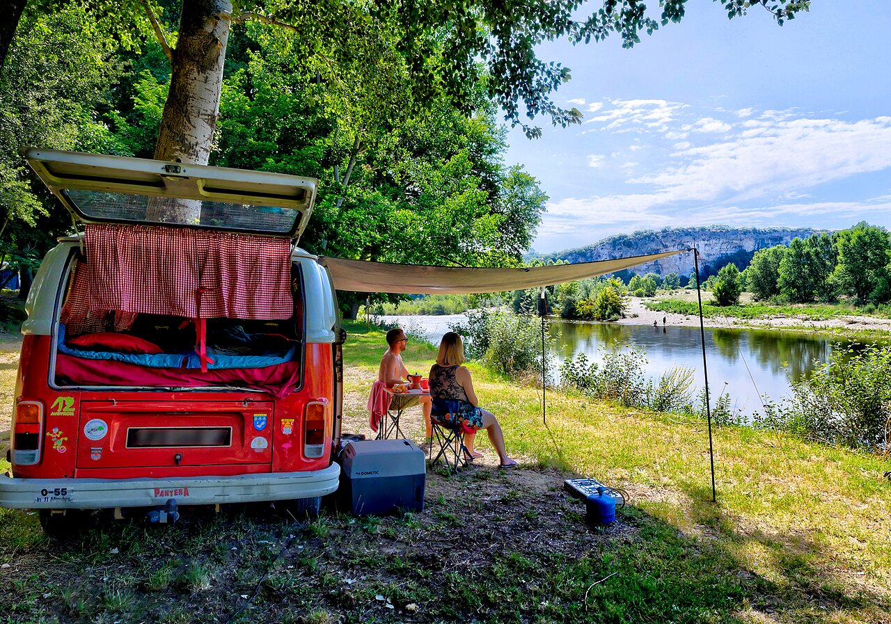 Vintage camper van, couple, river, at CLICOCHIC Gorges du Gardon campsite in VERS PONT DU GARD (30).