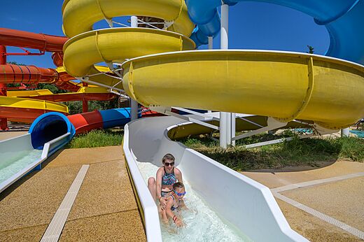 Mother and child on water slide at CLICOCHIC Gorges du Gardon campsite (30).