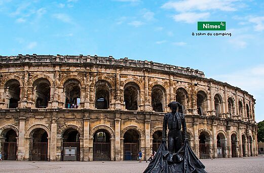 Roman amphitheater of N�mes and bullfighter statue, place to visit near the campsite.