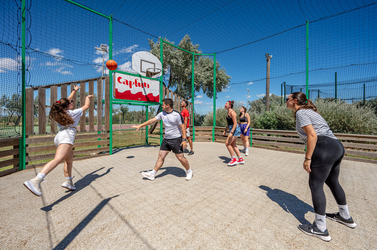 Basketball court, young people playing at CAPFUN Grande Cosse, Saint Pierre la Mer.